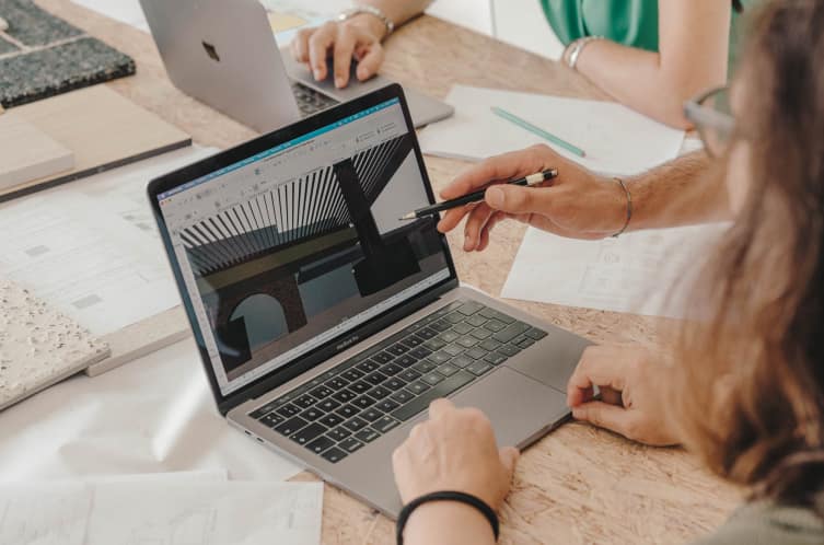 Person working on financial documents on a laptop