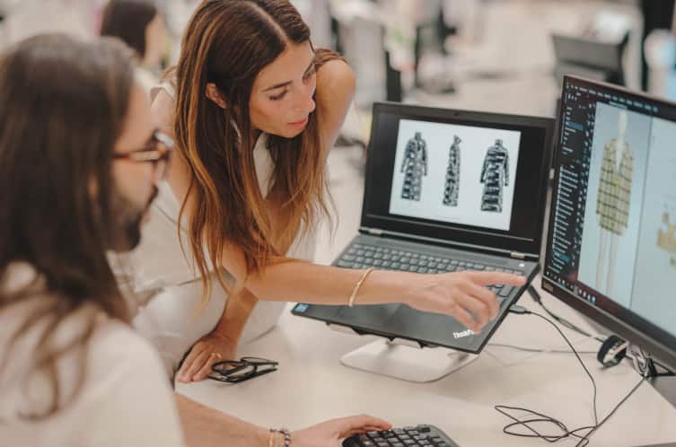 Team collaborating on a project at a desk with computers